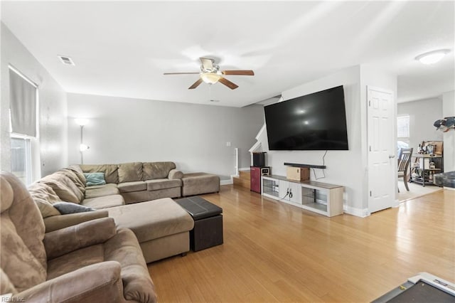 living room featuring ceiling fan and light wood-type flooring