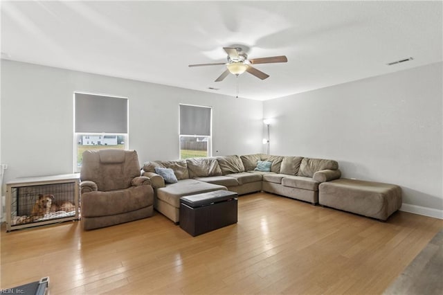 living room with ceiling fan and light hardwood / wood-style floors