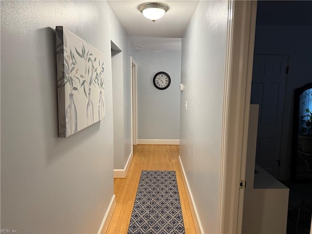 corridor with light hardwood / wood-style flooring