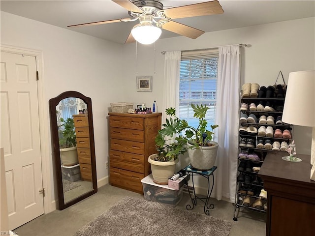 interior space with ceiling fan