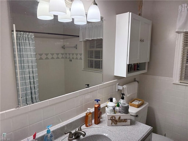 bathroom with sink, tile walls, and a shower with shower curtain