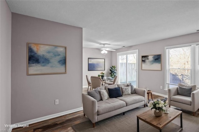 living room with ceiling fan and dark hardwood / wood-style floors