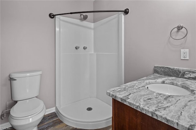 bathroom with vanity, a shower, wood-type flooring, and toilet