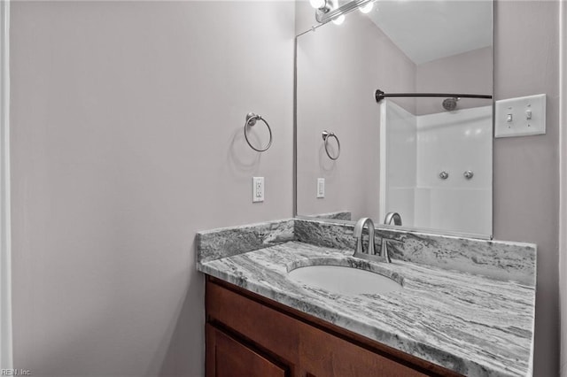 bathroom featuring vanity and a shower