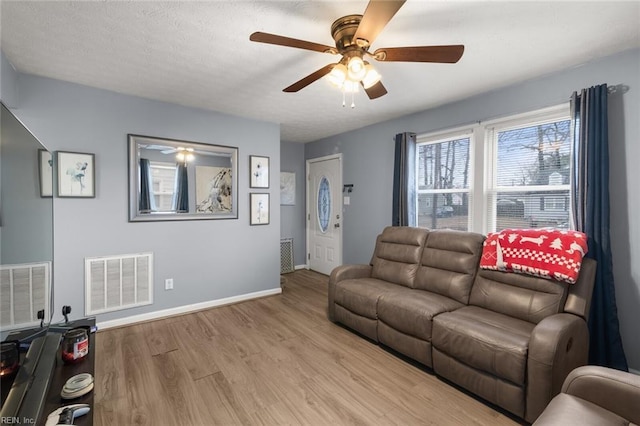 living room featuring ceiling fan and light wood-type flooring