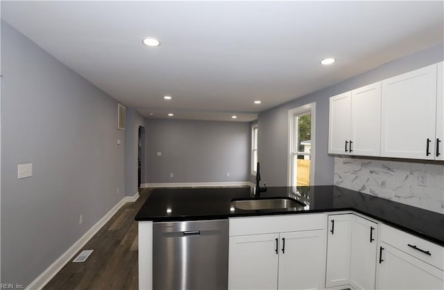 kitchen featuring dishwasher, sink, white cabinets, and kitchen peninsula