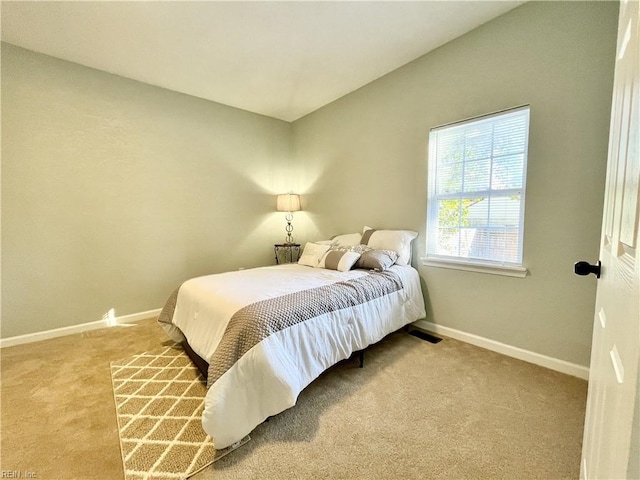 bedroom featuring vaulted ceiling and carpet