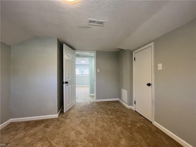 interior space with light carpet and a textured ceiling