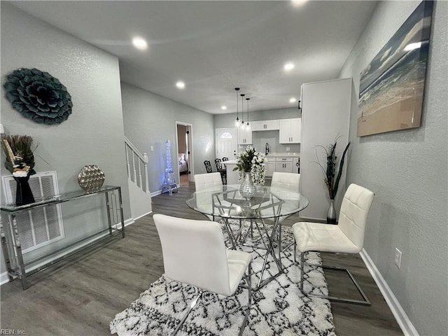 dining area featuring dark wood-type flooring and sink