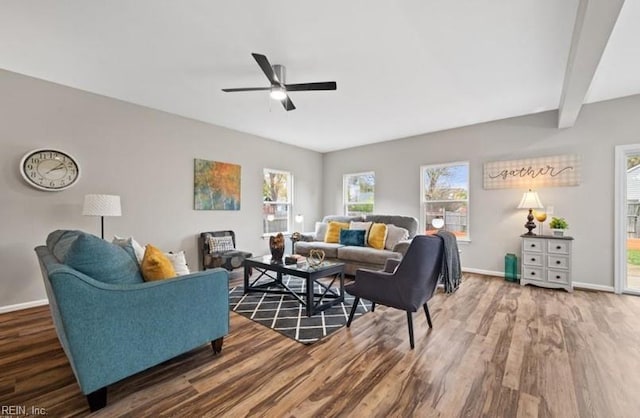 living room featuring beam ceiling, dark wood-type flooring, and ceiling fan