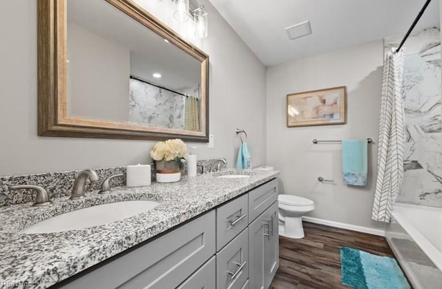 full bathroom featuring vanity, toilet, hardwood / wood-style floors, and shower / bath combo