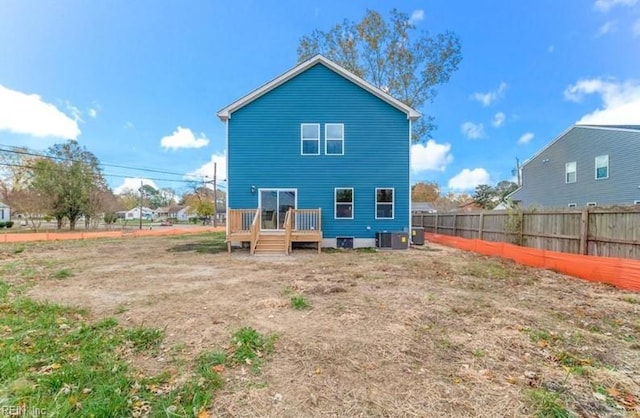 rear view of property with a wooden deck and central AC unit