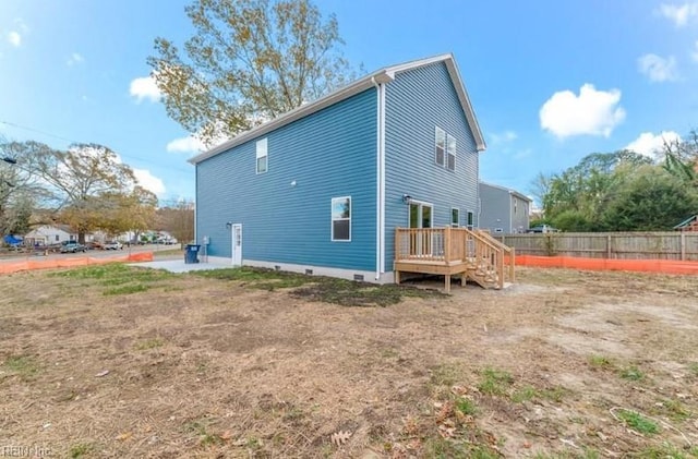 rear view of house featuring a deck