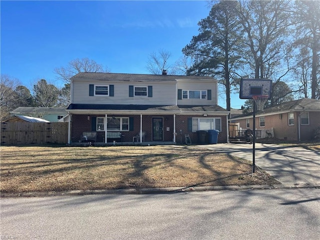 view of front property with a garage, covered porch, and a front lawn