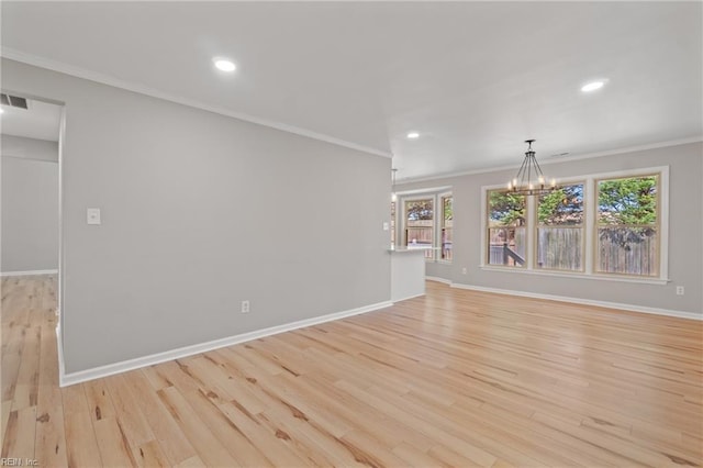 unfurnished living room with crown molding, a wealth of natural light, and light hardwood / wood-style flooring