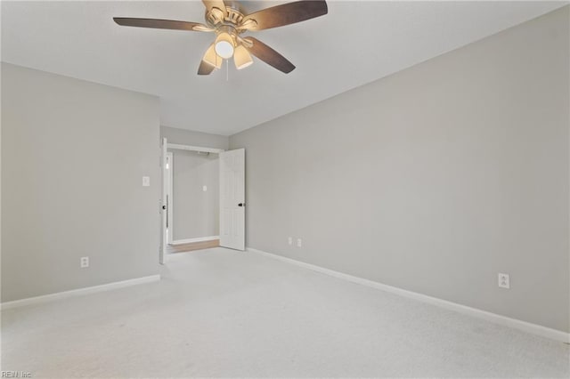 carpeted spare room with ceiling fan