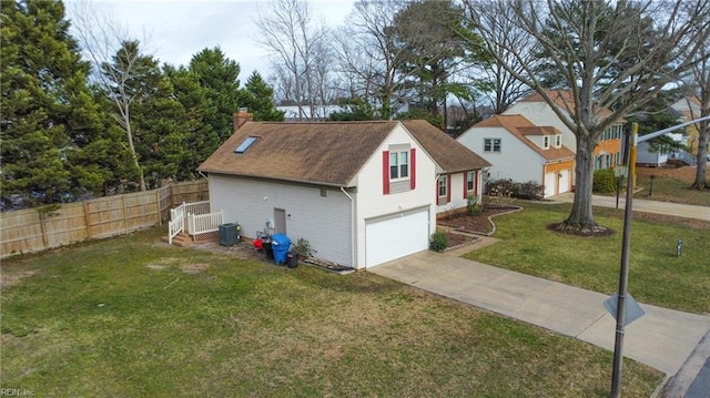 view of side of home with central air condition unit, a garage, and a yard