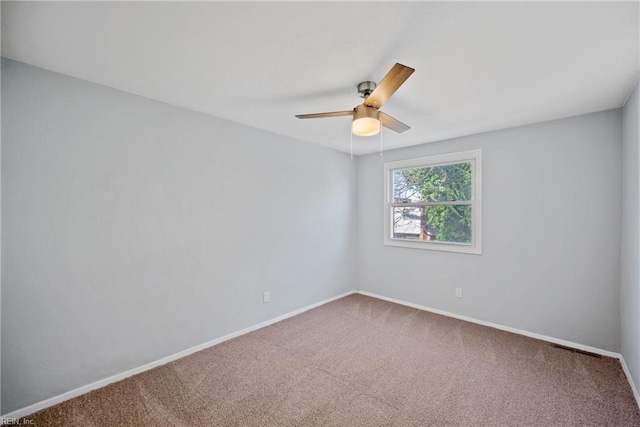 carpeted spare room with ceiling fan