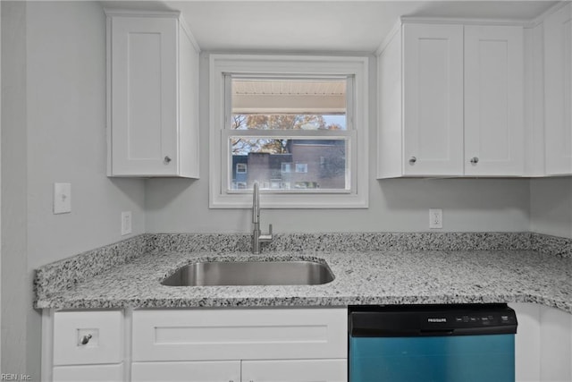 kitchen with light stone countertops, black dishwasher, sink, and white cabinets