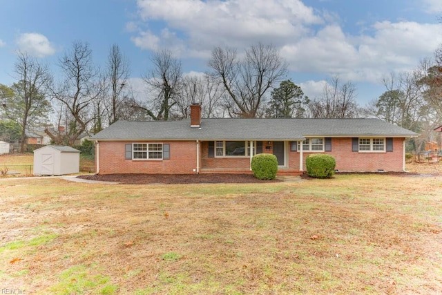 single story home with a front yard and a storage unit