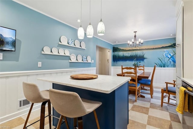 kitchen with white cabinetry, a center island, a breakfast bar, and decorative light fixtures