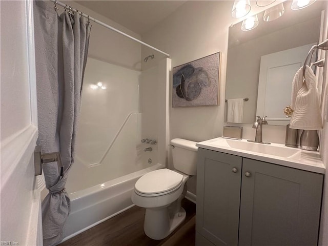 full bathroom with hardwood / wood-style flooring, vanity, toilet, and shower / tub combo