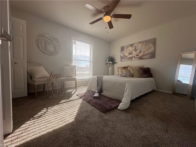 bedroom with ceiling fan and dark colored carpet