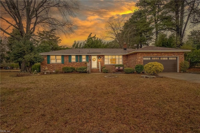 ranch-style house with a yard and a garage