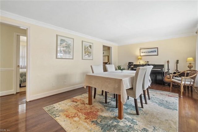 dining area featuring crown molding and dark wood-type flooring