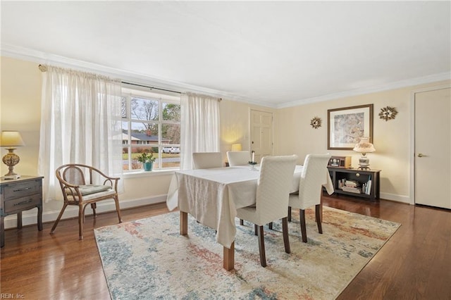 dining area featuring crown molding and dark hardwood / wood-style floors