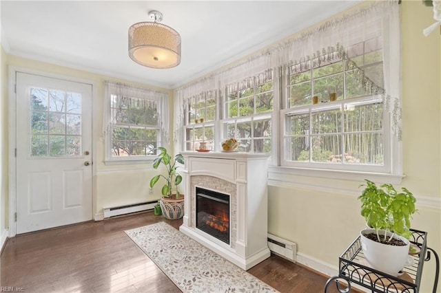 sunroom / solarium featuring a baseboard heating unit