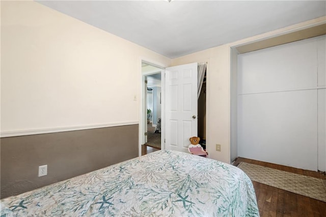 bedroom with a closet and dark hardwood / wood-style floors