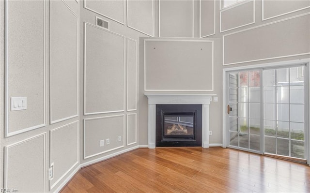 unfurnished living room with hardwood / wood-style floors