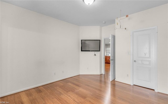 empty room with light hardwood / wood-style flooring