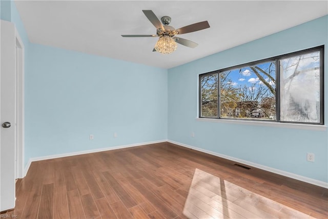 empty room with hardwood / wood-style flooring and ceiling fan