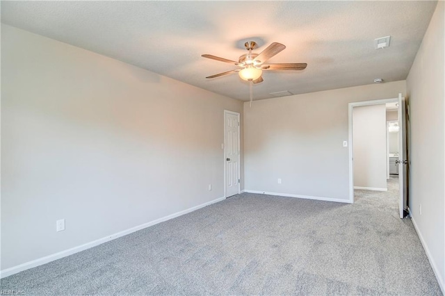 spare room with light carpet and ceiling fan