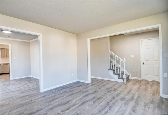 empty room featuring light hardwood / wood-style floors and a textured ceiling