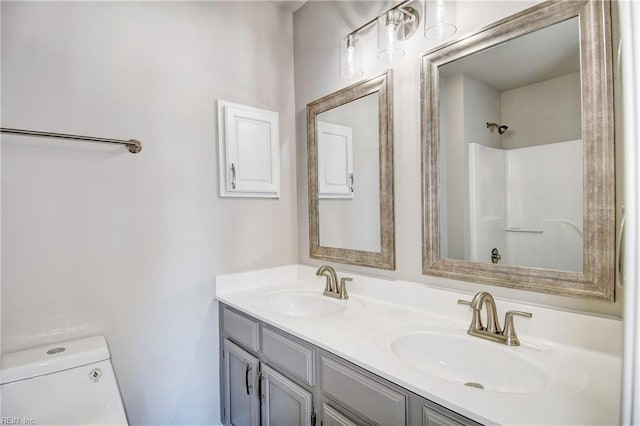 bathroom featuring vanity, a shower, and toilet