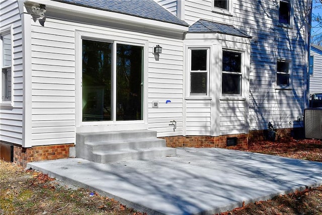 view of side of property with central AC and a patio