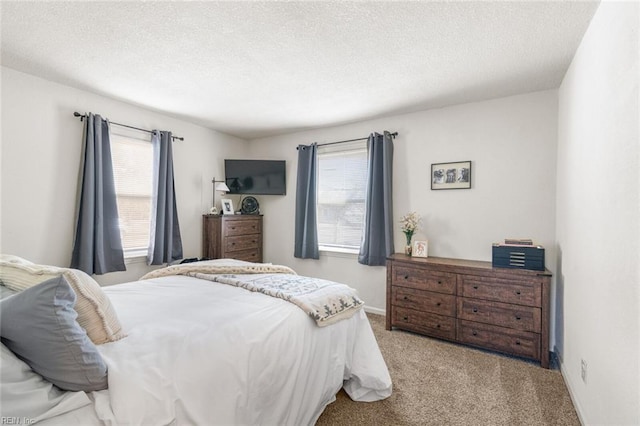 carpeted bedroom featuring a textured ceiling