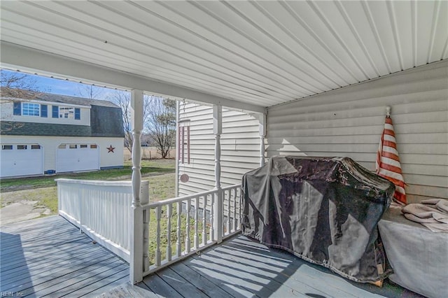 wooden deck with an outbuilding and a garage