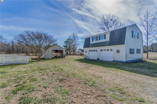 exterior space featuring a yard, an outdoor structure, and a garage