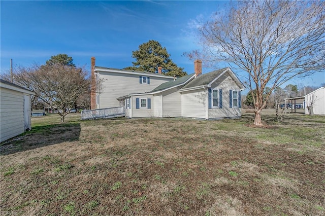 rear view of property with a yard