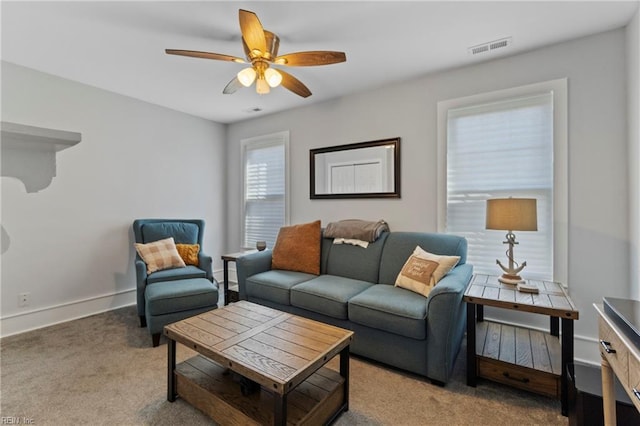 carpeted living room featuring ceiling fan