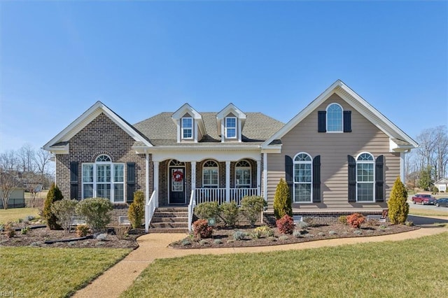 view of front of house with a front yard and a porch