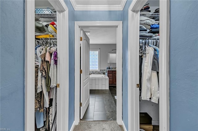 spacious closet with light tile patterned floors