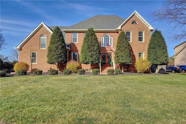 front facade featuring french doors and a front lawn