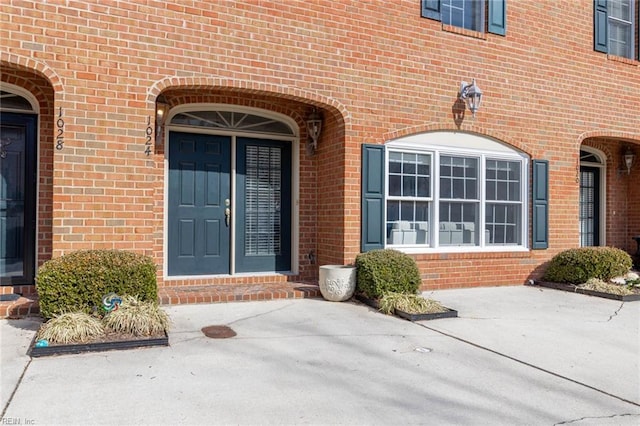 property entrance featuring brick siding