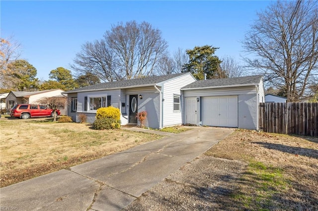 ranch-style house featuring a garage and a front lawn