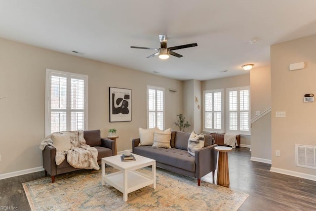 living room with dark hardwood / wood-style floors and ceiling fan